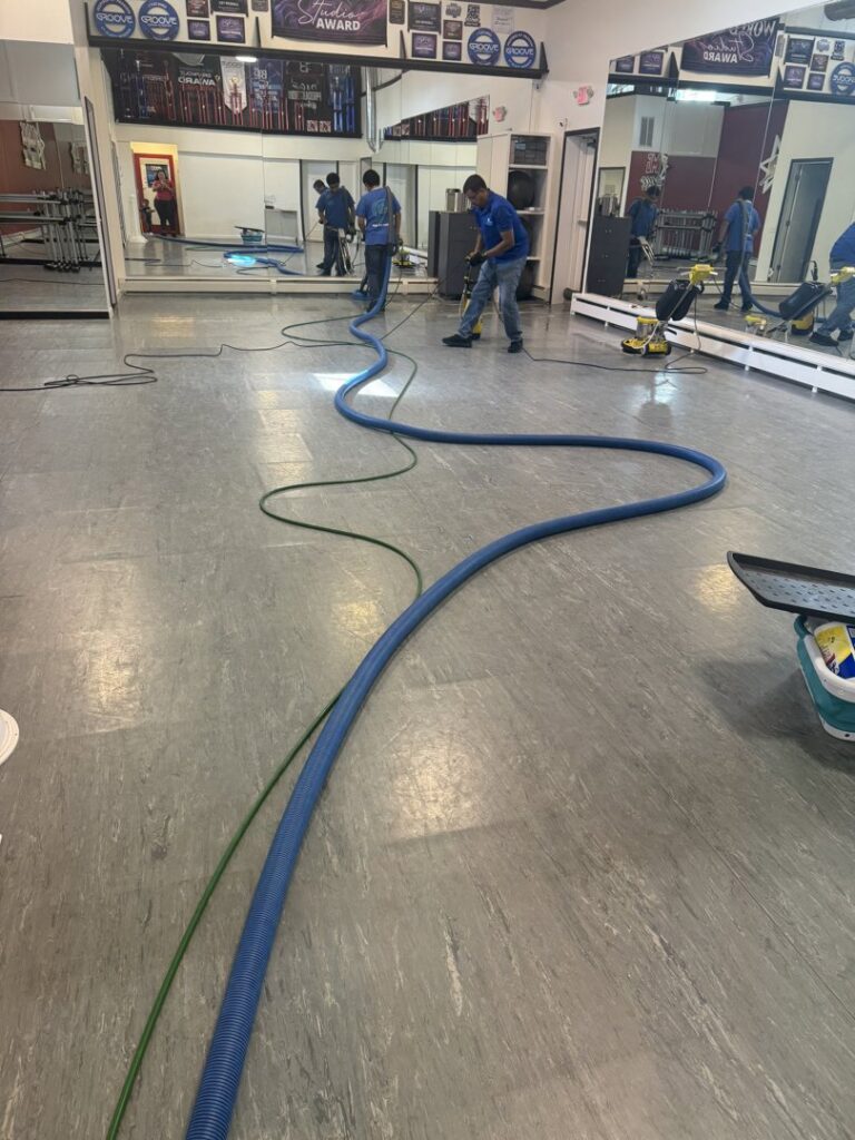 A technician using a handheld tool for upholstery cleaning by Rise N Shine Cleaning in San Antonio, TX