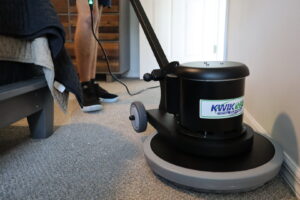 A technician from Rhode Island Kwik Dry using a professional carpet cleaning machine in a bedroom in Rhode Island.