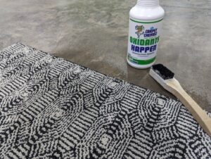 A technician using a carpet seaming iron to join carpet sections for installation by The Carpet Chemist in Louisville, KY.