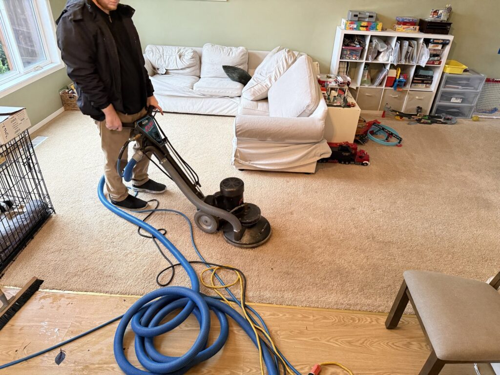 A technician from Heroic Carpet Cleaning Oregon operating a professional rotary carpet cleaning machine in Beaverton, OR