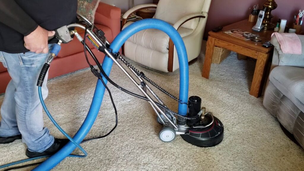 A technician operating a rotary carpet cleaning machine on a light-colored carpet for Mountain View Carpet Care in Vancouver, WA
