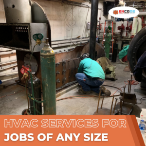 A technician welding an industrial boiler system, demonstrating large-scale HVAC services by Encode Corporation in Billings, MT.