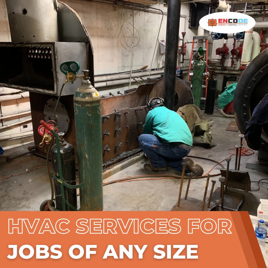 A technician welding an industrial boiler system, demonstrating large-scale HVAC services by Encode Corporation in Billings, MT.