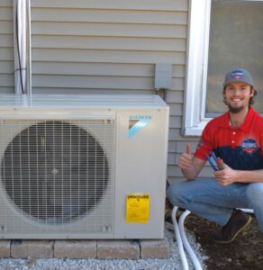 An Allegiance Heating & Air technician with a newly installed Daikin outdoor AC unit in Greenville, IN.