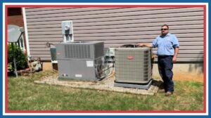 A U.S. HVAC Services technician standing next to two outdoor HVAC units after installation or service in Madison, AL.