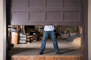 A technician working on a garage door panel, demonstrating service by Delta Garage Doors in Cleveland, OH