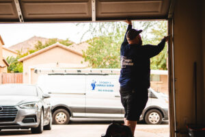 A technician from Smokey's Garage Door Company working on a garage door at a customer's home in Glendale, AZ.