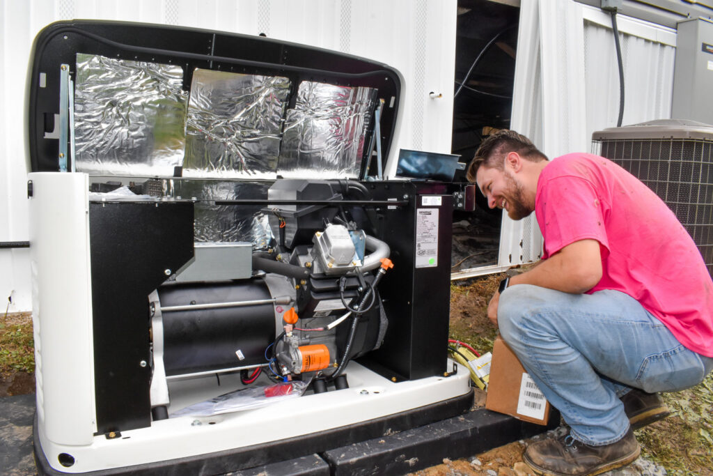 An Advanced HVAC and Plumbing technician working on an outdoor generator unit in Morgantown, WV.