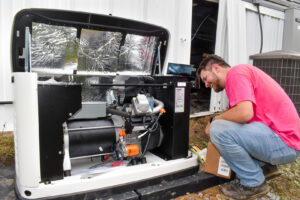 An Advanced HVAC and Plumbing technician working on an outdoor generator unit in Morgantown, WV.