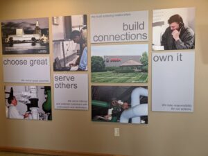 A technician working on large industrial pipes, demonstrating HVAC mechanical services by ENTEC Services, Inc. in Bartonville, IL