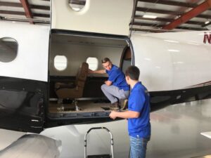 Mark's Carpet Cleaning technicians working on the interior of a private jet in Omaha, NE
