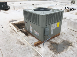 Technicians inspecting a newly installed rooftop HVAC unit for Schiller Heating & Cooling in Tempe, AZ.