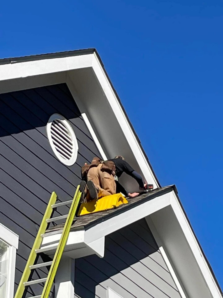 Sustainable Pest Systems technicians inspecting a residential roof for wildlife entry points in Raleigh, NC.