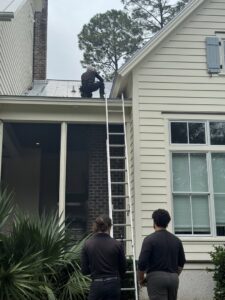 Pest control technicians inspecting a roof, performing a service for Pinnacle Pest Solutions in Hilton Head Island, SC