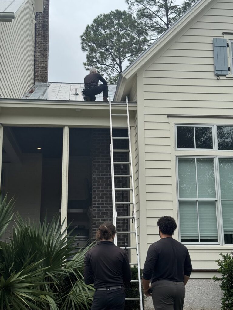 Pest control technicians inspecting a roof, performing a service for Pinnacle Pest Solutions in Hilton Head Island, SC
