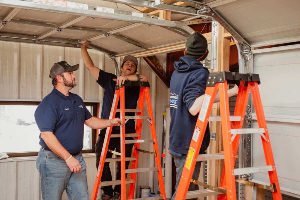 Front Range Raynor Garage Door & Service technicians installing a garage door opener system in Fort Collins, CO.