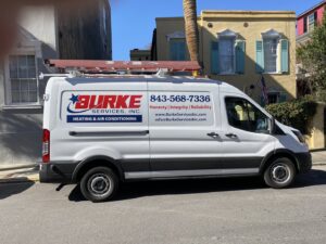 Burke Services, Inc. technicians installing a large commercial rooftop HVAC unit in Folly Beach, SC.