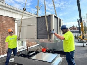 Technicians installing a large rooftop HVAC unit for Southern Comfort Heating & Cooling in Lexington, KY