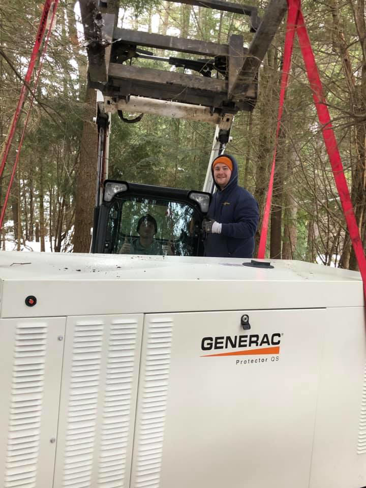 Technicians using heavy machinery to move a Generac Protector OS generator for installation by Great Lakes Power Generation in Williamsburg, MI.