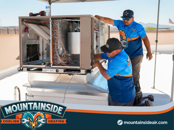 Two Mountainside Air technicians servicing a rooftop HVAC unit in Phoenix, AZ.