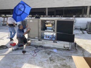 Tek-Aire Services Inc. technicians performing service on a commercial rooftop HVAC unit in Columbia, SC.