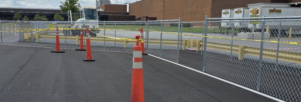 A temporary chain-link construction fence with caution tape installed by CSRA Solutions in Jackson, SC.