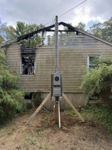 A temporary electrical service pole with a meter installed by Joshua Melendez Electrician LLC in New Bedford, MA.