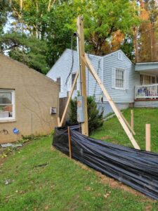 A temporary power pole with an electrical meter and conduit installed, showcasing work by 8Thirty Electric, Inc. in Johns Creek, GA.