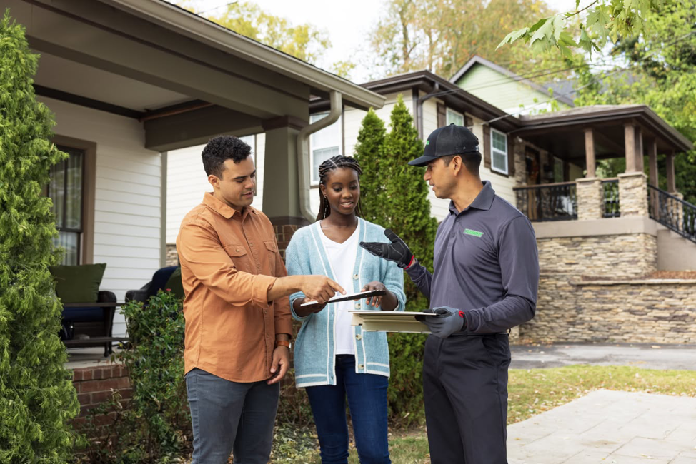 A Terminix technician consulting with customers outside their home in Springfield, IL.