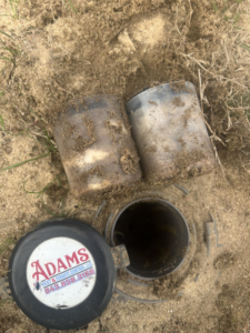 Termite bait stations being installed in the ground by Adams Pest and Termite Control in Austin, TX.