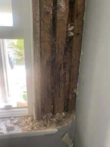 Severe termite damage visible on a wooden window frame, a problem expertly resolved by Mecaf Termite and Pest Control in Long Beach, CA