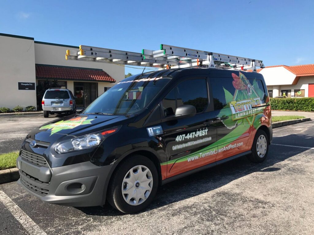A branded service van from Termite Lawn And Pest, Inc with ladders on the roof, ready for pest control jobs in Orlando, FL.