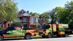 Termite Lawn And Pest, Inc service vehicles parked in front of a residential home in Orlando, FL, ready for pest control.