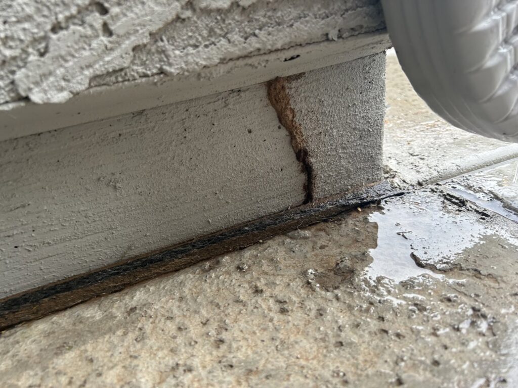 A close-up view of a termite mud tube on a concrete foundation, indicating a pest issue for Steadfast Pest Control in Queen Creek, AZ.
