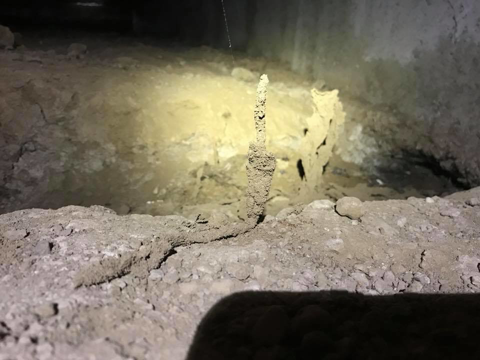 Termite mud tubes visible in a dark crawl space, indicating active pest infestation addressed by Innova Termite in San Jose, CA.