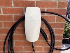 An exterior Tesla EV charger installation on a brick wall by Decatur Electrician Now in Decatur, AL.