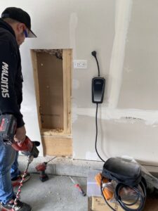 An exterior Tesla EV charger installation with conduit, completed by Neighborhood Electric in West Chicago, IL.