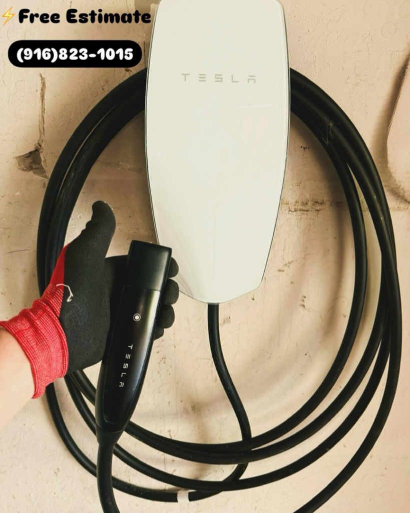 A hand holding a Tesla EV charger connector, representing EV charger installation services by AO Electric Inc. in Sacramento, CA.
