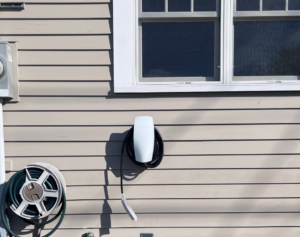 A Tesla EV charger installed on the exterior wall of a home by ANT POWER LLC in Tacoma, WA.