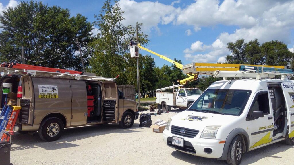 A Tesla EV charger and electrical panel installation in a garage, completed by Neighborhood Electric in West Chicago, IL.