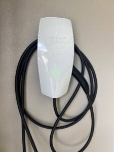 A Tesla electric vehicle charger professionally installed on a wall by Premo Electric in Spring Valley, CA