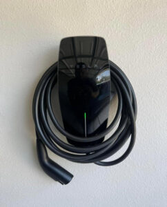 A Tesla EV charger professionally installed on a wall by Vitality Electric in Sacramento, CA.