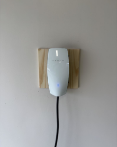 A newly installed Tesla electric vehicle charger on a wall by Zimmerman Electric Indy in Indianapolis, IN