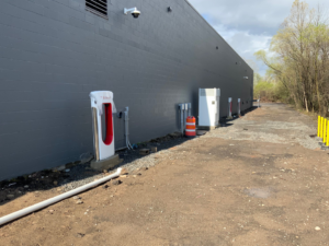 Exterior view of a building with Tesla EV charging stations installed by CM Armitage Electrical Contracting Inc in Rochester, NY.