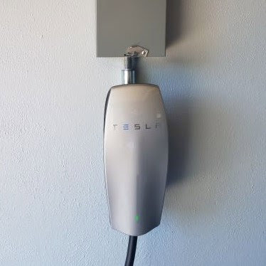 A close-up of a Tesla Wall Connector EV charger, professionally installed by Smith Electrical Contractors, Inc. in El Cajon, CA.