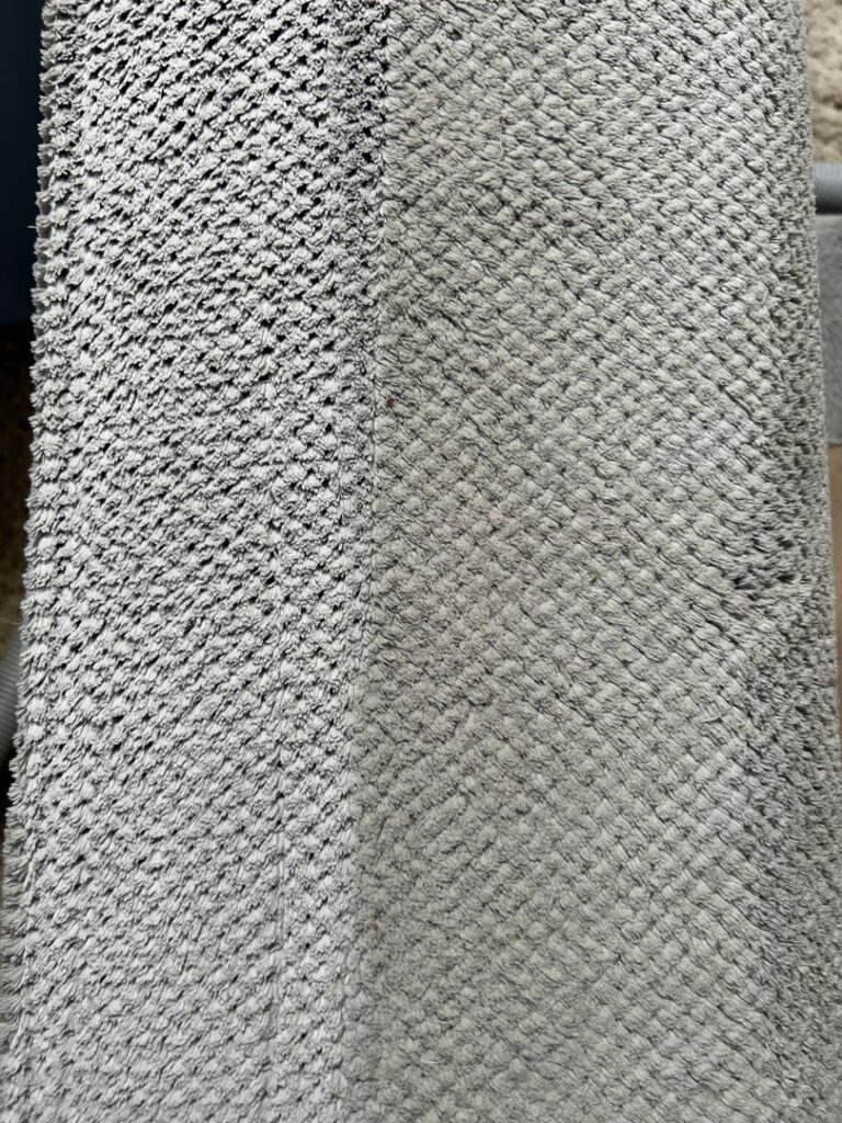 A textured carpet showing the cleaning results with a clear division by Radiant Rugs Carpet Cleaning in Spokane, WA.