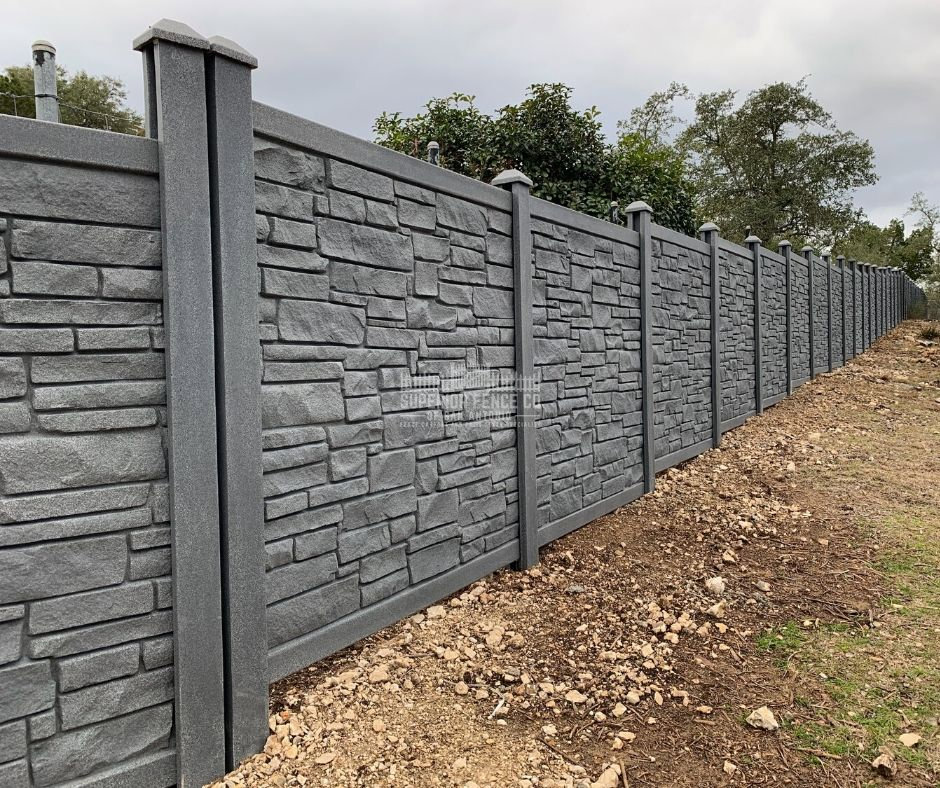 A durable concrete fence with a decorative stone texture, installed by Superior Fence Co. of San Antonio, TX.
