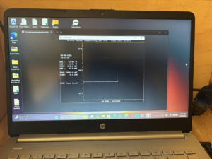 A laptop displaying an in-situ thermal conductivity test for geothermal system design by Jackson Geothermal in Mansfield, OH.