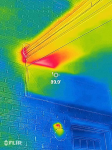 A thermal scan showing a hot spot under a building's eave, indicating a bee nest, by A&E Bee Extraction and Control in Mount Pleasant, SC.