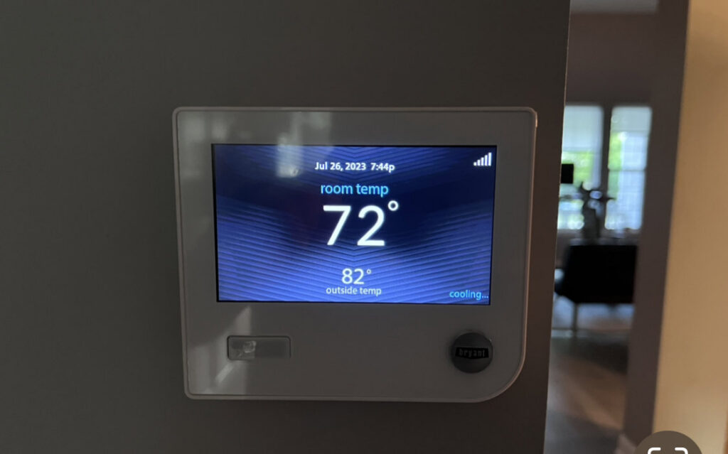 A smart thermostat displaying cooling status and room temperature, installed by Kustom Heating & Cooling in Elgin, IL